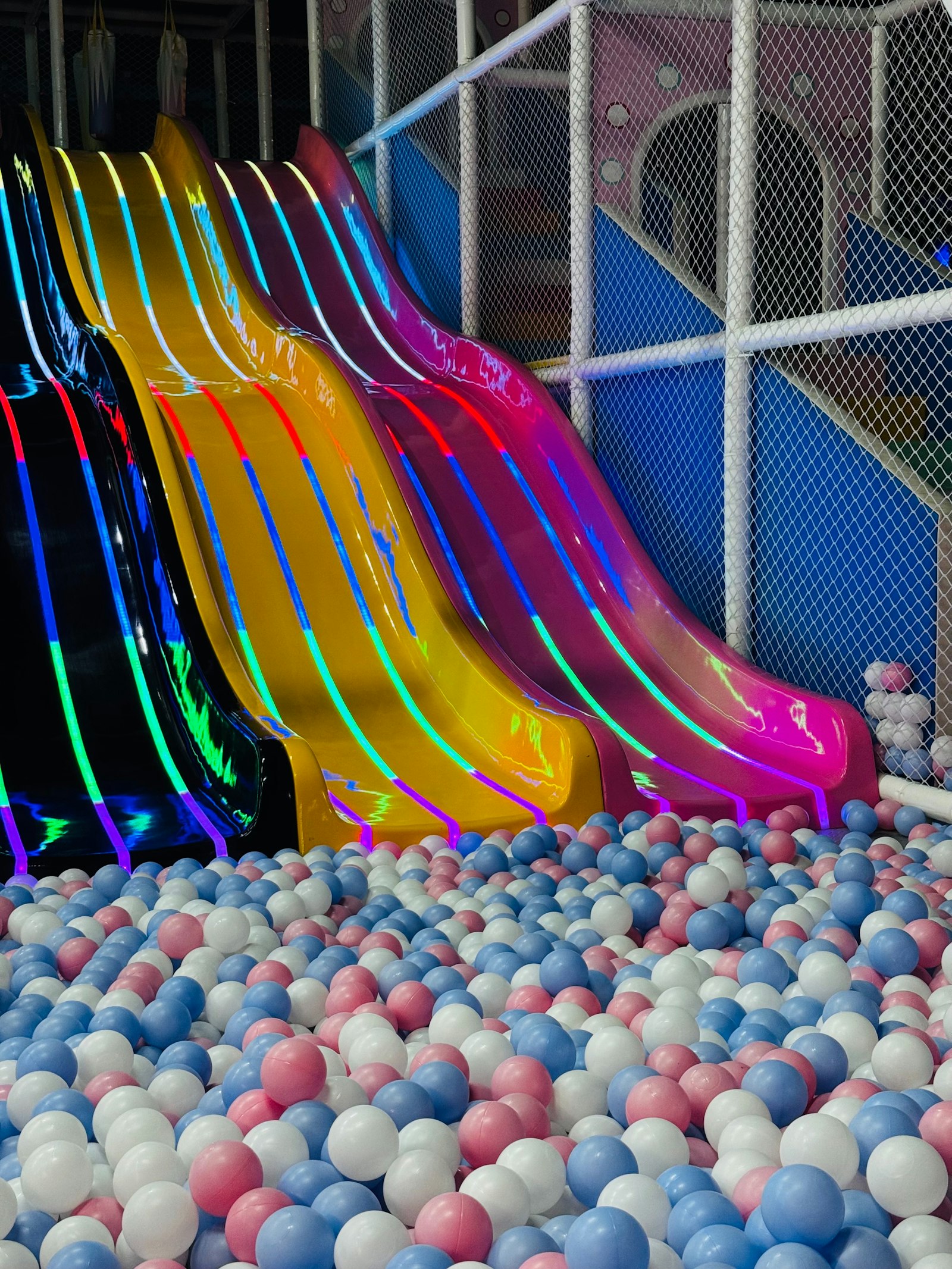 Play structure with slides running into a ball pit